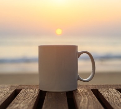 Coffee mug on oceanfront deck overlooking the beach | Sun-Surf Realty Emerald Isle Rentals