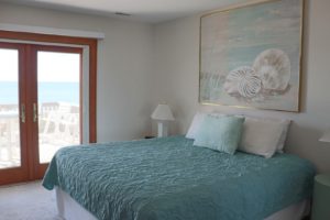 A cozy bedroom to relax in after exploring Emerald Isle on bike rentals.