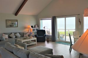 The living room of an Emerald Isle vacation rental to relax and check the weather from.