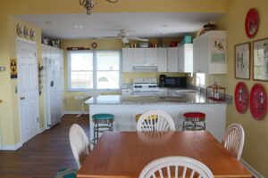 The kitchen and dining area of an Emerald Isle rental to cook meals in using ingredients from local grocery stores.