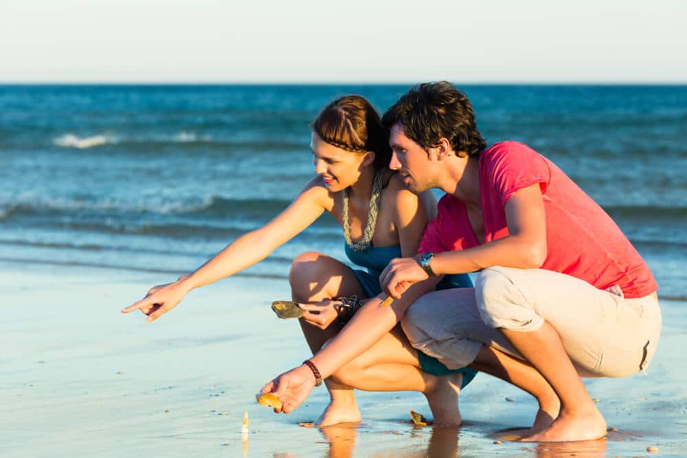 A couple looking for shells during one of the low tides in Emerald Isle.