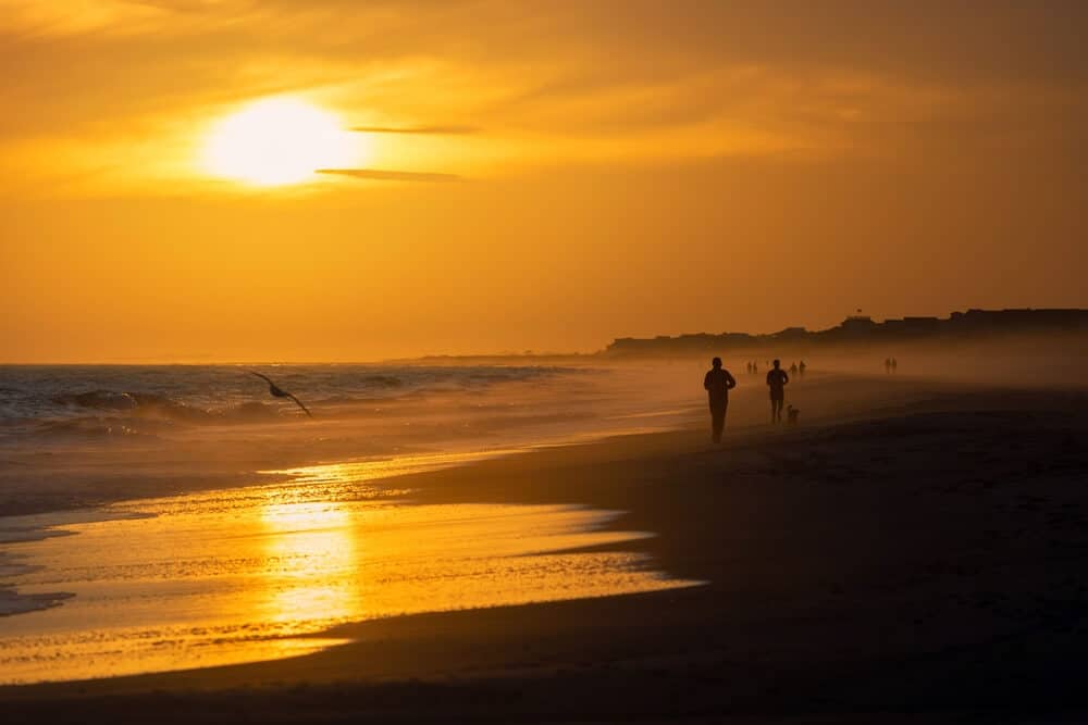 People walking on the beach on a fall vacation to Emerald Isle in North Carolina.